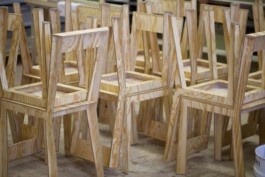 Stühle aus dünnem Sperrholz, aufeinander gestapelt. 